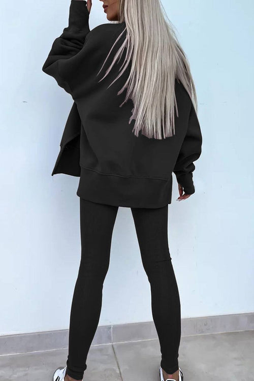 Woman wearing black TimelessChic ultra comfortable two-piece set with oversized sweatshirt and fitted leggings seen from back