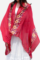 Red embroidered travel-must shawl with floral detailing, lightweight and versatile wrap for stylish protection.