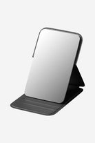 Compact travel pocket mirror with durable black PU leather case and clear glass reflection surface