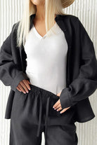 woman wearing black 100 cotton wanderlust two-piece set with loose shirt and drawstring pants