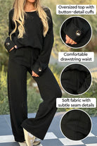 Black comfortable two-piece set with oversized button-cuff top and wide-leg drawstring pants, soft fabric and subtle seam details