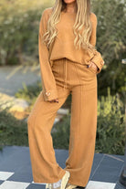 Camel-colored relaxed fit two-piece set with wide-leg pants and button-cuff sweater for comfortable travel and versatile styling