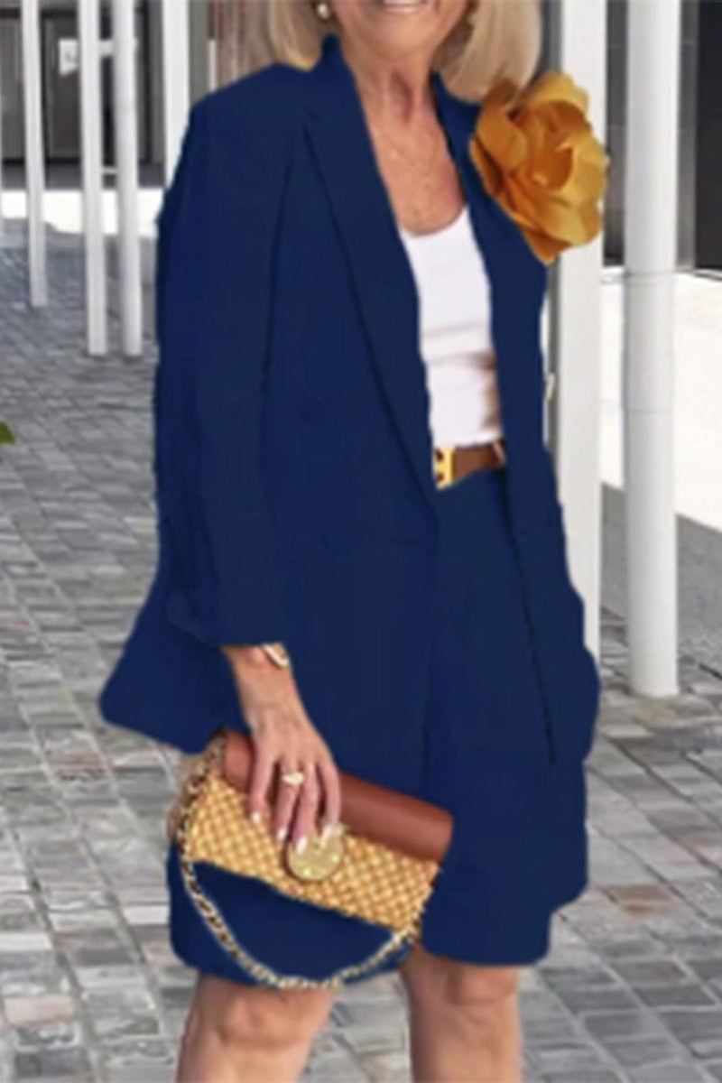 Stylish navy blazer and shorts two-piece set for women with flower accessory and woven clutch bag