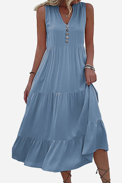 Bohemian tiered midi dress in blue with V-neck and button detail, sleeveless summer dress with flowing tiers and empire waist.