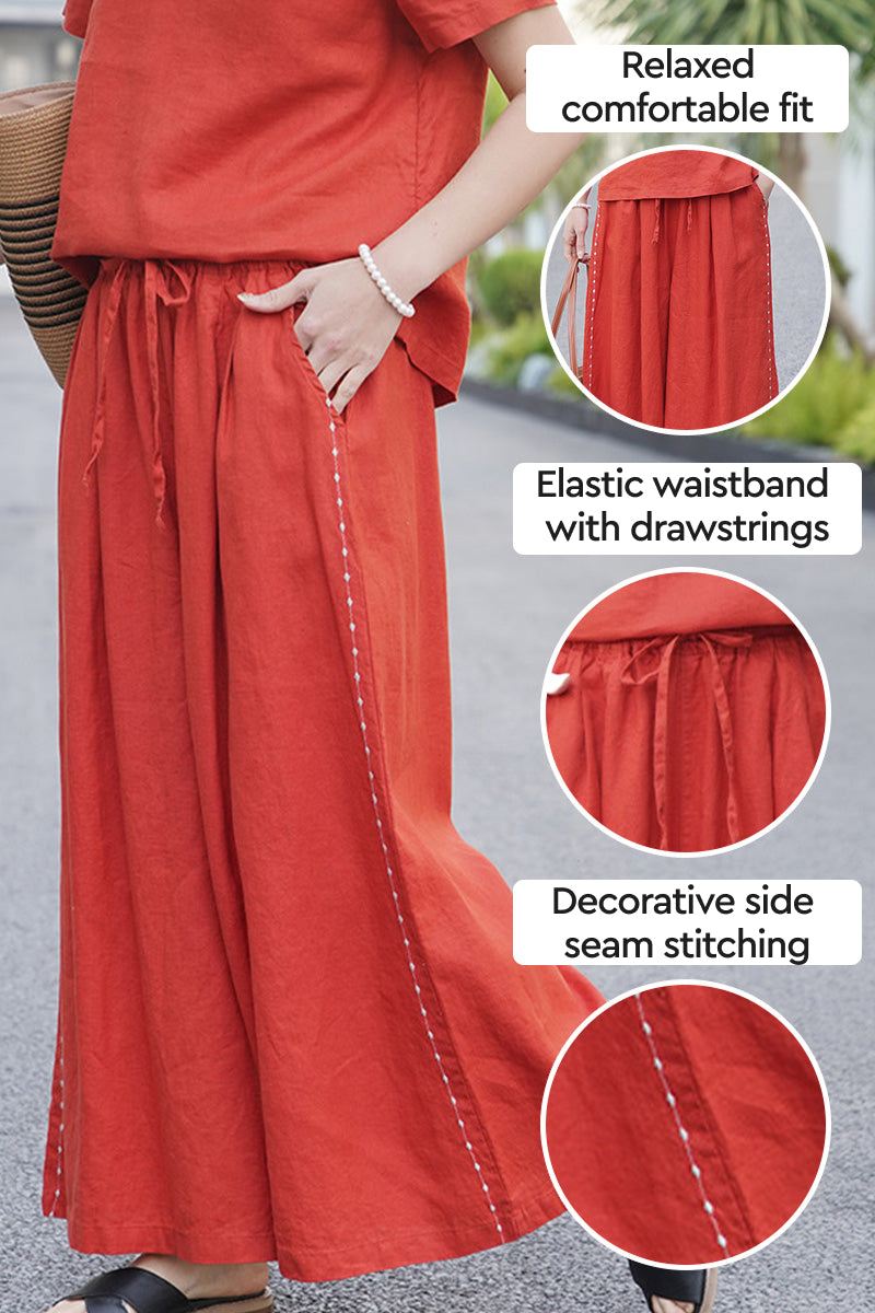 100% linen wide-leg pants with elastic waistband, drawstrings, and decorative side seam stitching in relaxed fit