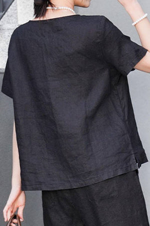 Back view of woman wearing breathable black 100% pure linen classic shirt with short sleeves and relaxed fit