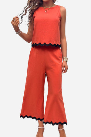 Women's scalloped trim sleeveless top and wide leg pants set in orange with black scalloped edges