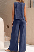 Women's sleeveless wide leg pants set in navy blue, lightweight and wrinkle-resistant fabric, perfect for comfortable travel and versatile styling.