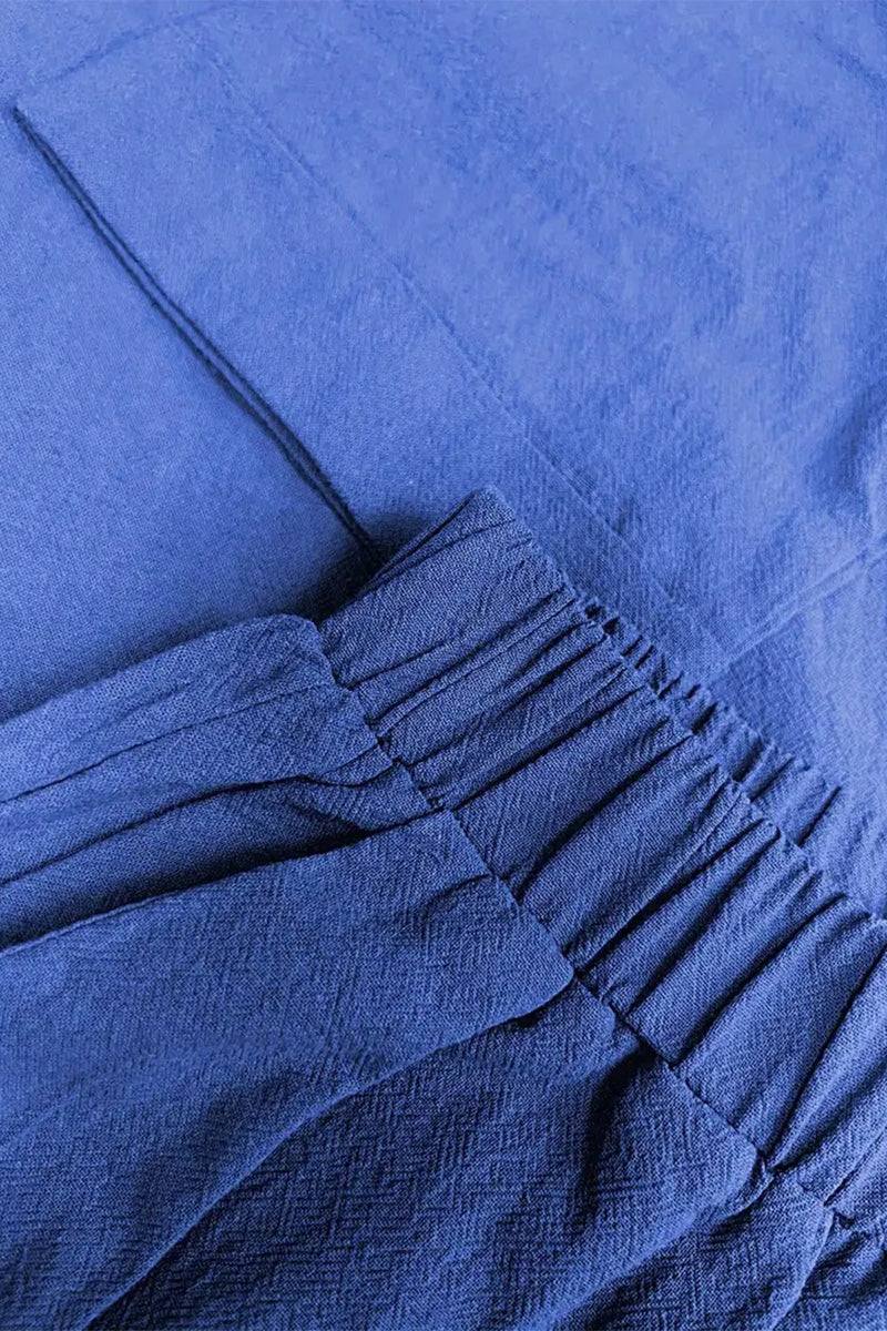 Close-up of a blue 100% cotton two-piece set with elastic waistband and textured fabric