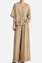 Woman wearing 100% linen stone-washed beige button-up top with double pockets and wide-leg palazzo pants set
