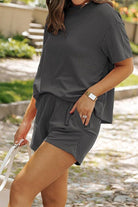 Woman wearing a comfortable textured gray relaxed-fit top and shorts set for slow mornings outdoors