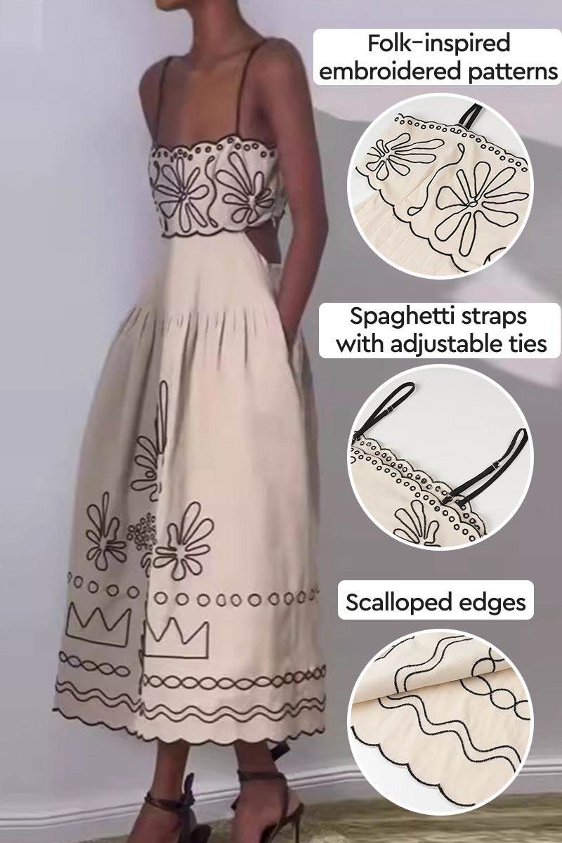 Artisan embroidered beige bohemian maxi dress with folk-inspired floral patterns, adjustable spaghetti straps, and scalloped edges.