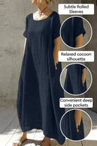 Breeze Cocoon Dress in navy with rolled sleeves, relaxed cocoon silhouette, and deep side pockets for casual elegance