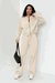 The Voyager Zip Set beige zip-front sweatshirt and wide-leg joggers on model with black handbag and white sneakers