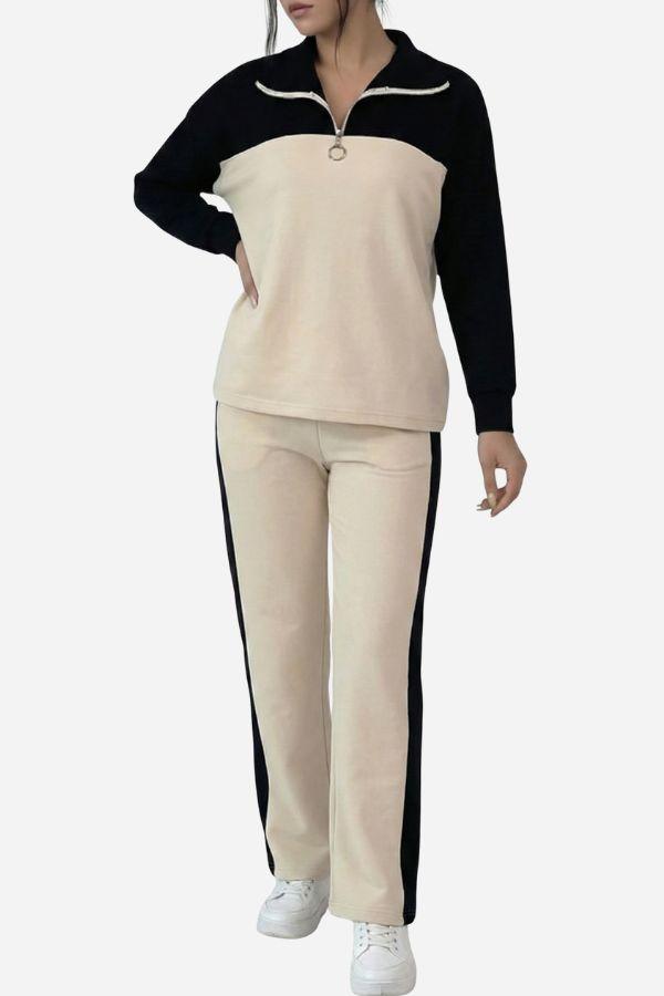 Woman wearing Colorblock Comfort Leisure Set with half-zip pullover and wide-leg pants in cream and black colors