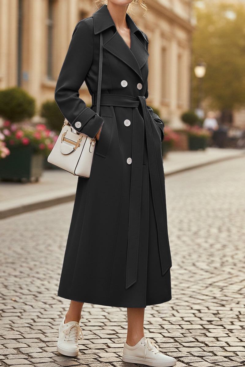 Black Timeless Retro Belted Trench Coat with double-breasted design, adjustable waist belt, and full-length cut worn with white sneakers and handbag on city street