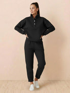Woman wearing black Warm & Easy Two-Piece Set with pullover hoodie and matching pants.