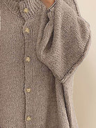 Oversized button-front knit cardigan with balloon sleeves and gold-tone buttons in chunky knit texture