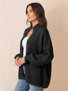Oversized button-front knit cardigan with balloon sleeves and gold-tone buttons in chunky knit texture