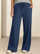 Soft knit wide-leg pants with elastic drawstring waist and breathable fabric.