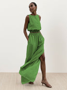 Lightweight linen-blend set with sleeveless top and wide-leg pants featuring elastic waistband and side slits for breathable comfort