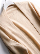 Long Australian Merino wool cardigan with open front and patch pockets, perfect for layering in cooler seasons