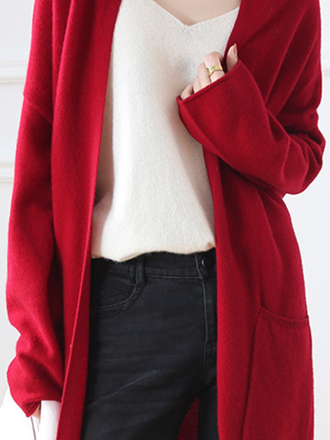 Long Australian Merino wool cardigan with open front, patch pockets, and ribbed cuffs.