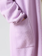 Long Australian Merino Wool cardigan with open front and patch pockets, ideal for layering in cooler seasons.