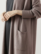 Longline open-front cardigan made from 100% Australian Merino Wool with front pockets and ribbed cuffs.