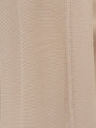 Woman wearing oversized long-line loungewear set with short-sleeve pullover and wide-leg pants.