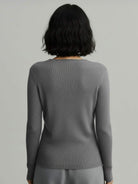 Lightweight 100% cashmere round neck pullover sweater with long sleeves and hip-length cut.