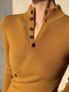 Slim fit asymmetric wrap ribbed knit top with diagonal button closure and flared cuffs