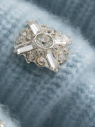 Close-up of 100% Alashan cashmere ribbed knit cardigan with diamond collar and crystal buttons.