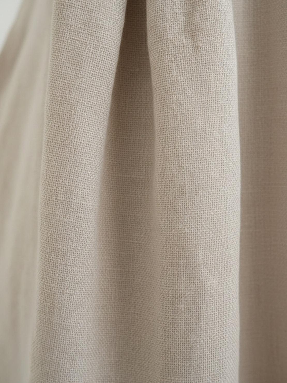 Lightweight cotton-linen empire waist dress with natural crinkle texture and deep pockets