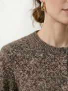 Chunky marled knit merino wool cardigan with contrasting buttons and ribbed cuffs.