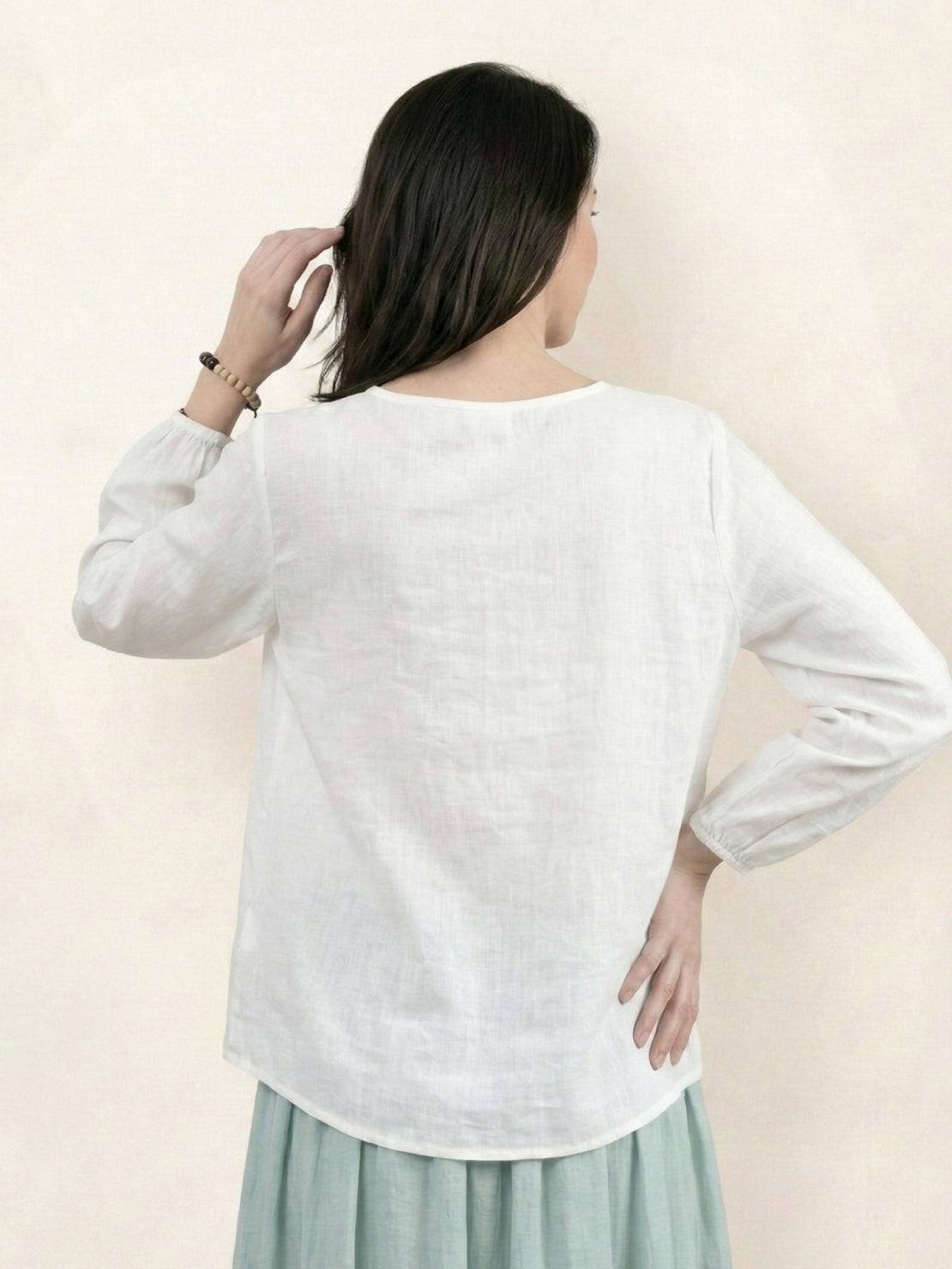 100% cotton-linen embroidered blouse with relaxed boxy fit, 3/4 balloon sleeves, and tonal floral embroidery on shoulder