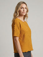 Floral jacquard pleated top with 3D floral texture, flutter sleeves, and relaxed A-line silhouette