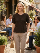 Floral jacquard pleated top with 3D floral texture, flutter sleeves, and relaxed A-line silhouette