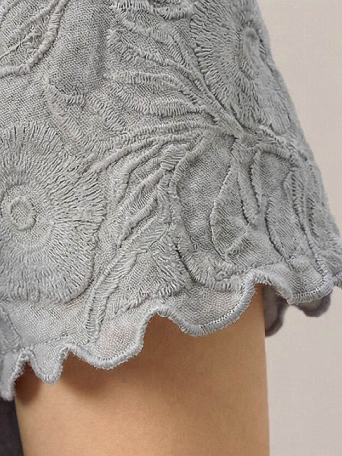 Lightweight floral jacquard pleated top with flutter sleeves and relaxed A-line silhouette