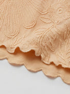 Lightweight floral jacquard pleated top with flutter sleeves and relaxed A-line fit