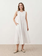 Sleeveless cotton linen pleated midi dress with pintuck bodice and A-line calf-length skirt in relaxed fit