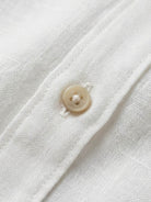 100% linen dropped-shoulder shirt with oversized fit, side slits, and rollable long sleeves