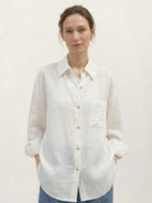 Loose 100% linen dropped-shoulder shirt with side slits and rollable cuffs for relaxed hip-length fit