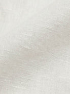 100% linen dropped-shoulder shirt with oversized fit, long rollable sleeves, side slits, and relaxed hip-length cut