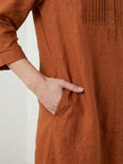 Relaxed A-line 100% cotton linen dress with pintuck pleats, 3/4 sleeves, side slits, and breathable fabric.