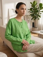 Oversized 100% linen blouse with frog-button closure and curved hem in lightweight, semi-sheer fabric