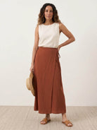 Army green asymmetrical wrap maxi skirt with side tie waist closure and flowing hem