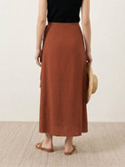 Asymmetrical wrap maxi skirt with side tie and flowy fabric in vibrant magenta color