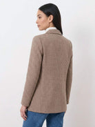 Black and white houndstooth commuter blazer with structured shoulders and double-button closure