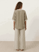 Woman wearing striped wide-leg co-ord set with oversized top and palazzo pants in multiple colors